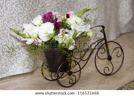 wedding arrangement. bouquet of flower on a bike