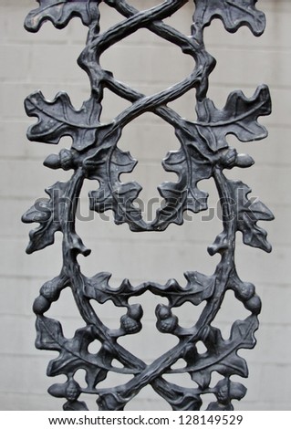 vertical orientation close up of vintage wrought iron detail with leaves, acorns and branches intertwined / Vintage Acorns