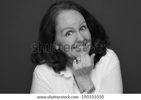 horizontal orientation close up in black and white of a single woman with a happy, excited look on her face / Enthusiastic Employee