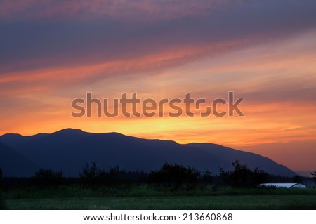 horizontal orientation in high dynamic range (HDR) of sunset over the Selkirk Mountain Range in northern Idaho, USA / Sunset over the Selkirks