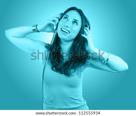 Young  woman portrait with headphones tinted in blue