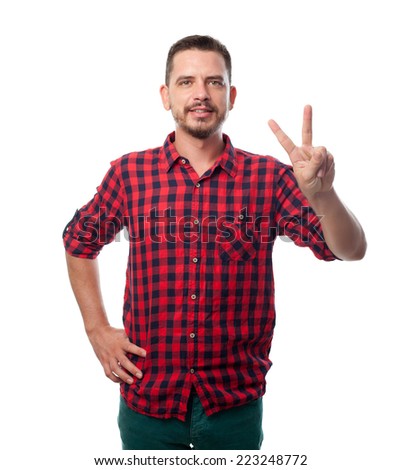 Young man over white background. Doing the victory symbol