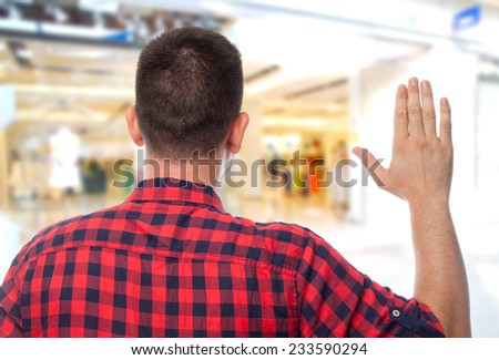 Man with red shirt over shopping center background. Swearing