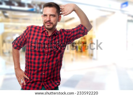 Man with red shirt over shopping center background. Looking funny