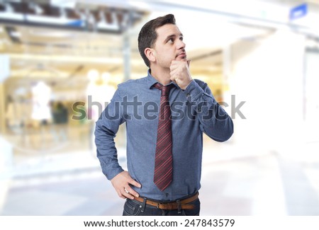Man wearing a blue shirt and red tie. He is is thinking on something