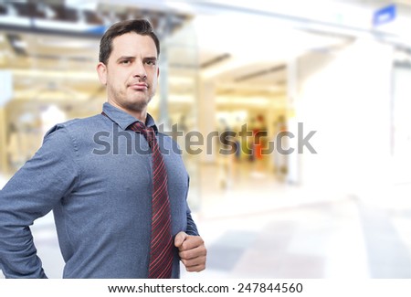Man wearing a blue shirt and red tie. He looks happy