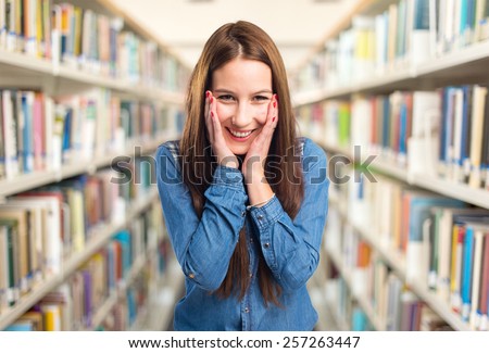 Trendy young woman looking happy. Over library background