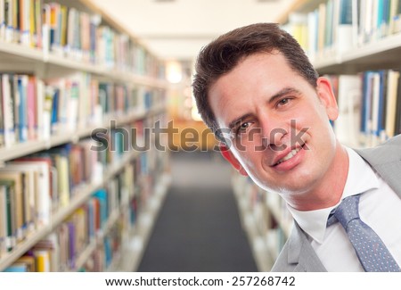 Business man with grey suit. Portrait. Over library background
