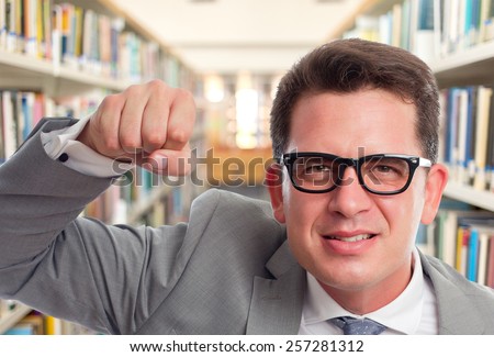 Business man with grey suit. He is looking upset. Over library background