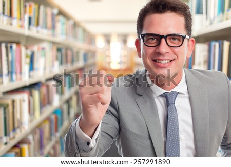 Business man with grey suit. He is looking happy. Over library background