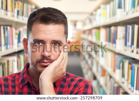 Man with red squares shirt. Portrait. Over library background