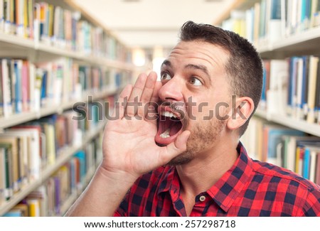 Man with red squares shirt. He is screaming. Over library background