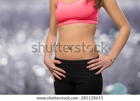 Young woman slim belly closeup