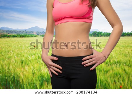 Young woman slim belly closeup
