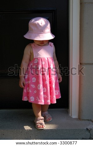 Toddler in pink stepping out and into the sun