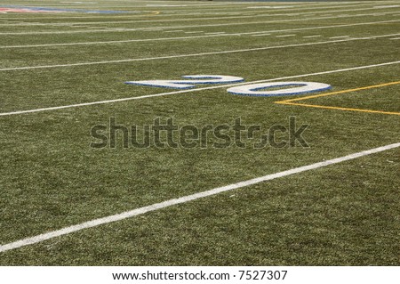 Twenty yard line of artificial turf football field.