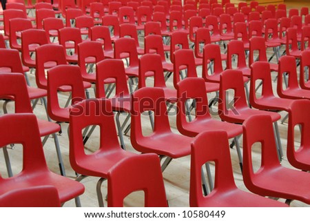 Red chairs arranged in rows for presentation