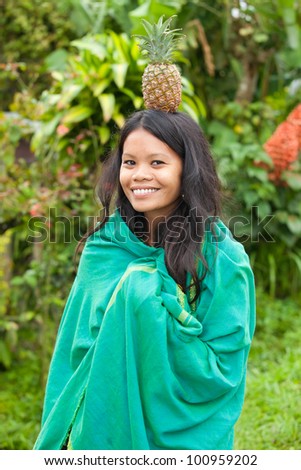 South-east asian woman with pineapple on her head