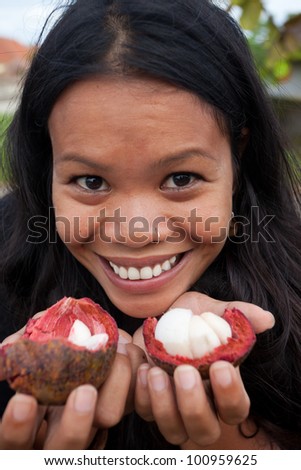 South-east asian woman with freshly opened mangostins.