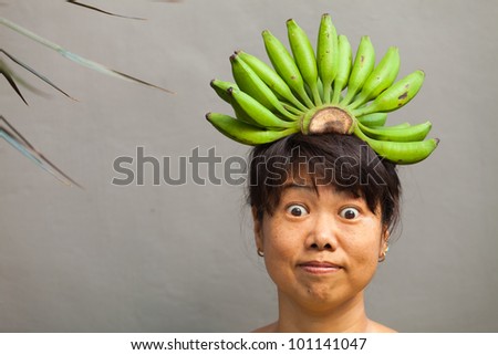 Happy and healthy woman with banana crown on her head