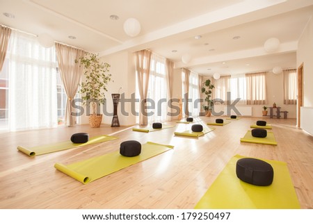 Beautiful, empty naturally lit yoga studio.