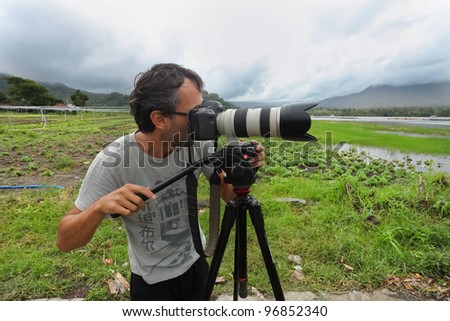 LAKE BATUR, BALI - JANUARY 21. Photojournalist Ognjen Maravic documenting life on Lake Batur on January 21, 2012 in Bali, Indonesia. Changing cultures due to tourism is one main topic worked on.