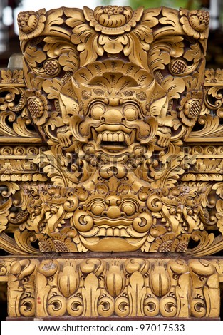 Balinese wooden sculpture of mask dragon face with golden paint