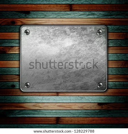 Metal plaque on wooden background