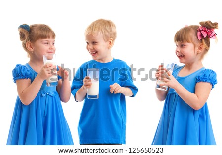Little girls-twins and boy are drinking milk of glasses in their hands and are laughing on white background.