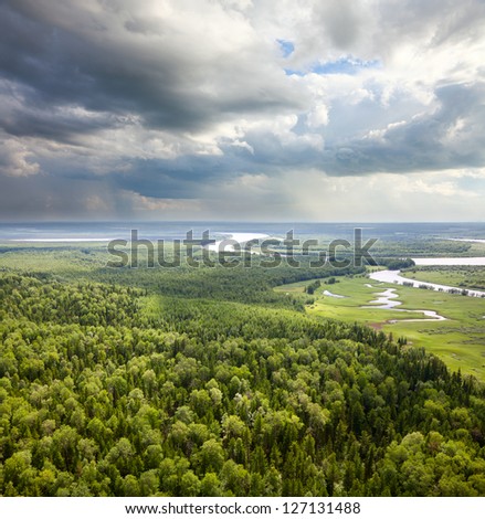 Aerial view of lowland of forest river a summer during a flight.