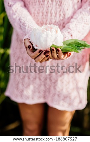 closeup picture of woman hands holding lotus flower.