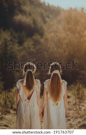 two girls standing back