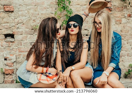 three beautiful girls rest on the street
