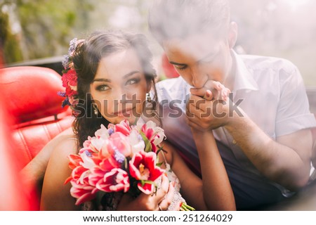 Young couple in vintage cars