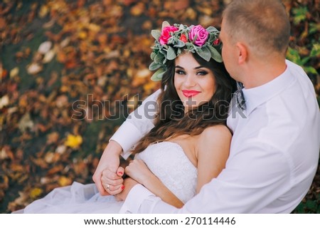 Happy newlyweds in park. Portrait of loving young bride and groom