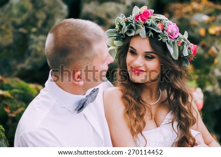 Happy newlyweds in park. Portrait of loving young bride and groom