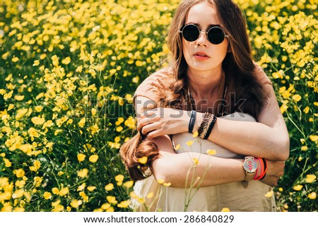 Romantic hippie girl standing in a field. Summer. Hippie style.