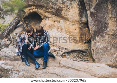 couple in love, walk on the rocks Dovbush Carpathian Mountains