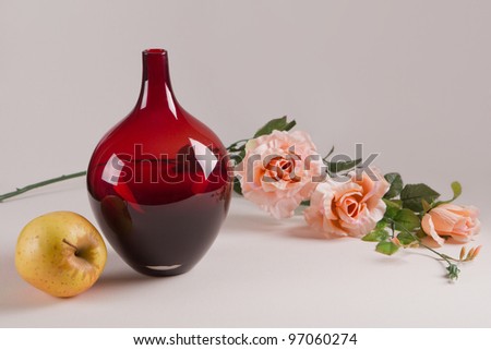 The vase, the apple and the rose.