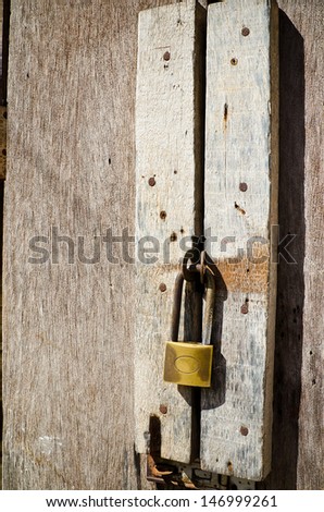 Old rusty hardwood door with key lock