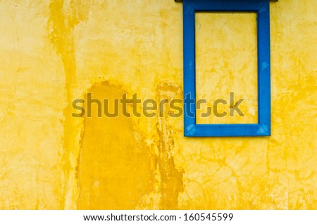 Blue window frame on yellow wall