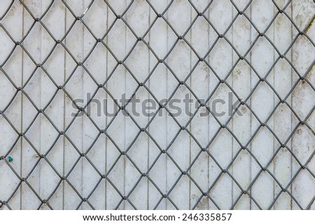 Closeup to old rusty steel fence on white wall