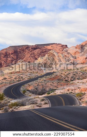 road curves on hill landscape in nevada desert, valley of fire state park