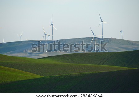 wind mill on green wheat farm hill in palouse, washington