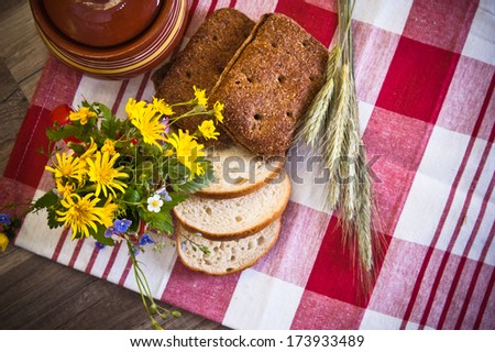 Still life with bread, flowers and pot