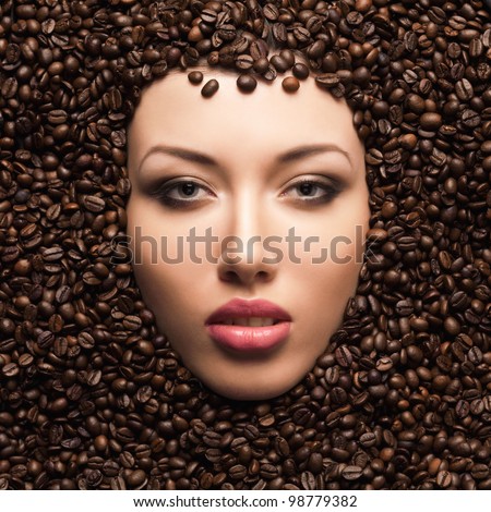 Beautiful woman face in coffee beans