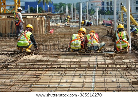 MALACCA, MALAYSIA - DECEMBER 19 2015: Construction workers fabricating floor slab reinforcement bar at the construction site in Malacca, Malaysia.