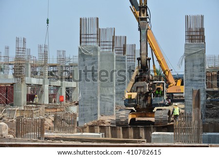 SELANGOR, MALAYSIA - MARCH 15, 2016: Sheet pile cofferdam driven machine at the construction site. The machine drove the sheet pile to the earth using vibrated hydraulic arm. Workers control.