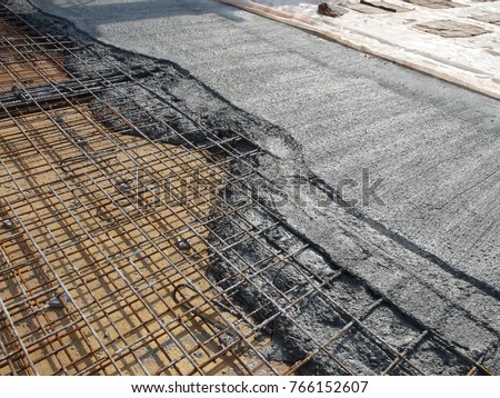 MALACCA, MALAYSIA -JULY 26, 2016: The wet concrete poured on a steel reinforcement bar to form strong floor slabs called reinforce concrete floor slab.