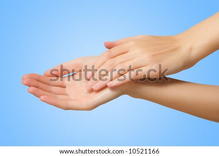 slim female hand on blue background